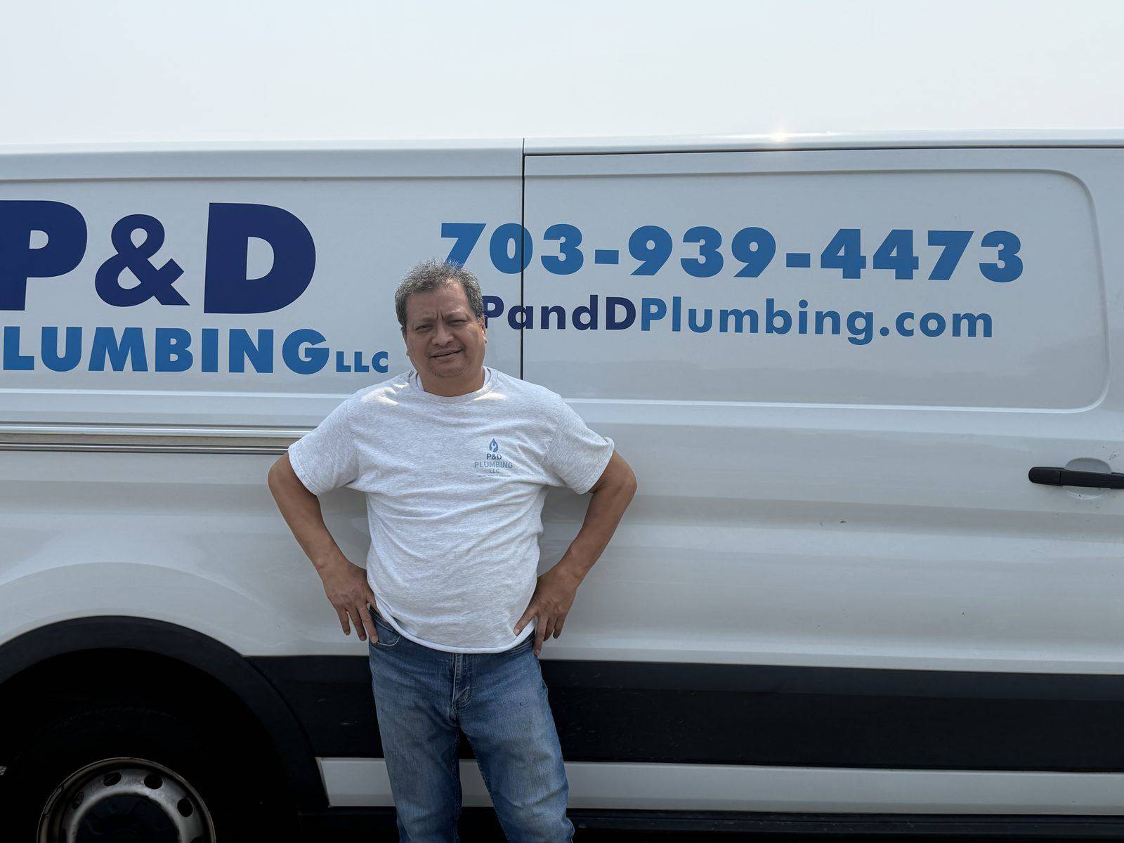 Wint, owner of P & D Plumbing, Master Plumber and Gas Fitter, standing in front of the company van