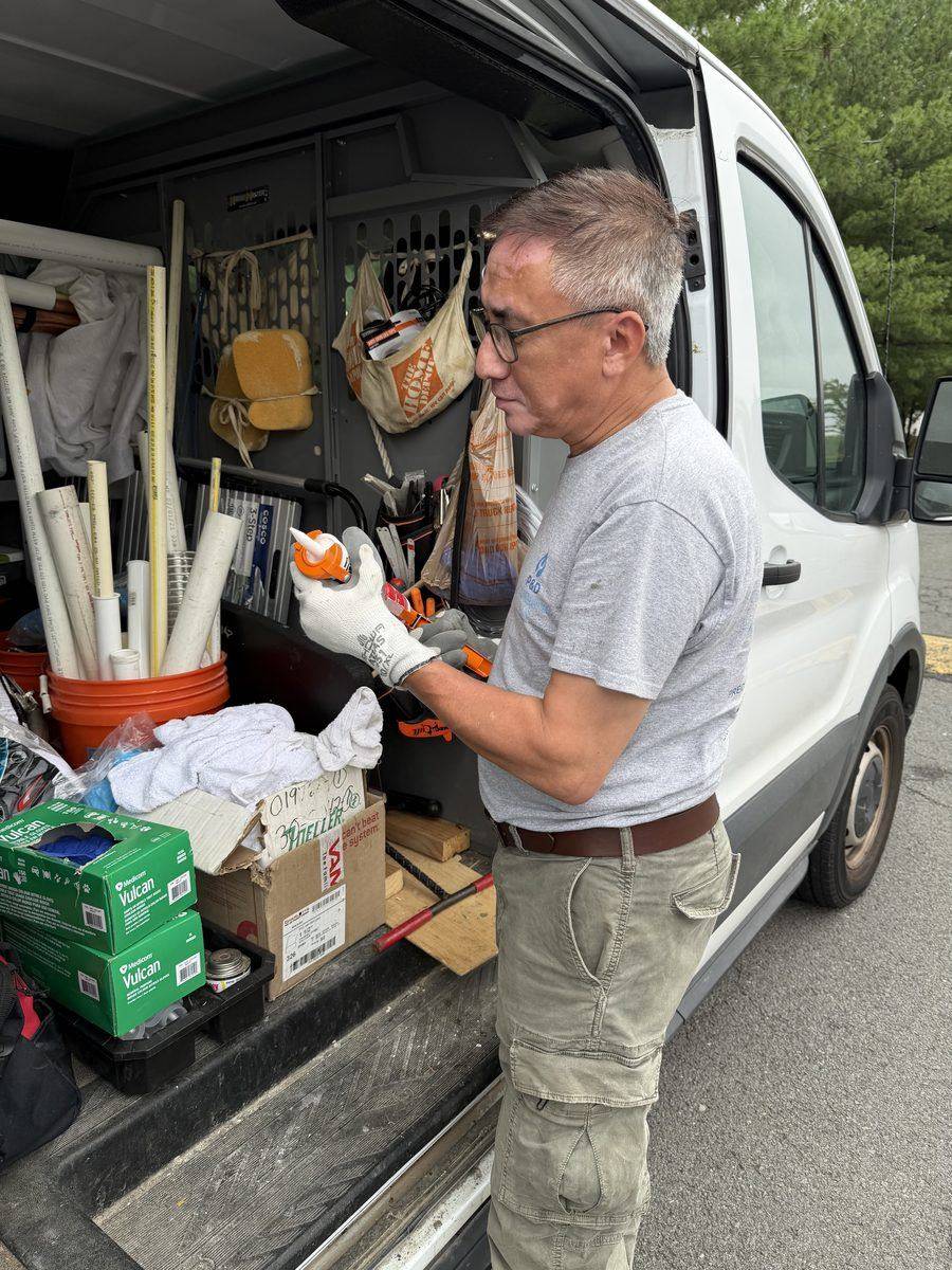 P & D Plumbing technician organizing equipment in service van
