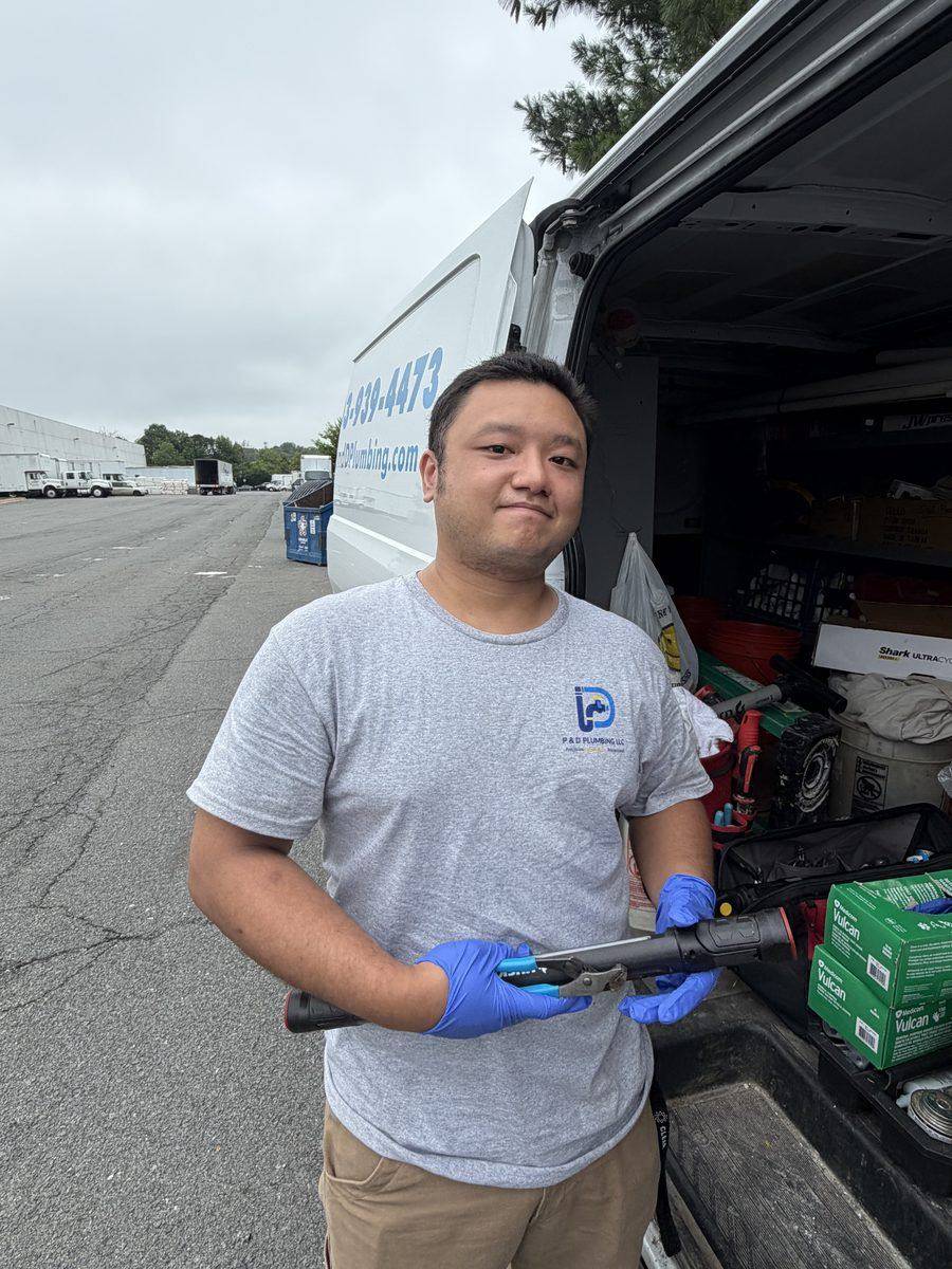 P & D Plumbing technician preparing tools at the service van