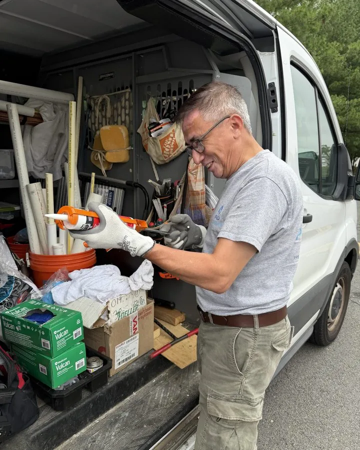 P & D Plumbing technician preparing materials at the service van